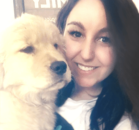 Selfie of April hugging a puppy Golden Retriever